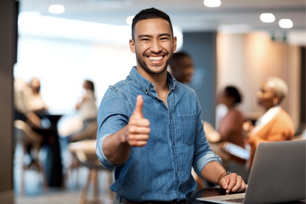 Guy smiling in camera with thumbs up gesture